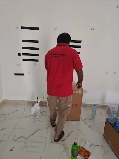 Expert Furniture Movers team packing boxes for a Zayed City move