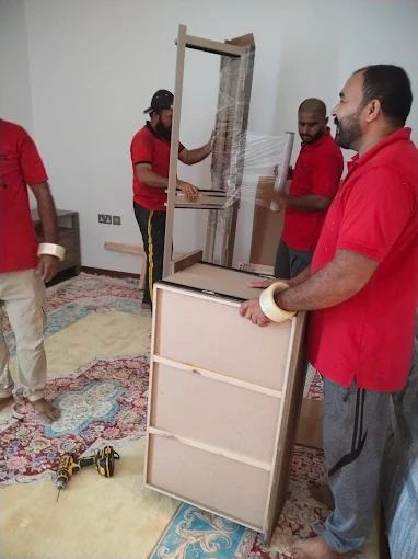 Expert Furniture Movers team packing bedroom furniture before an Al Rayyana move